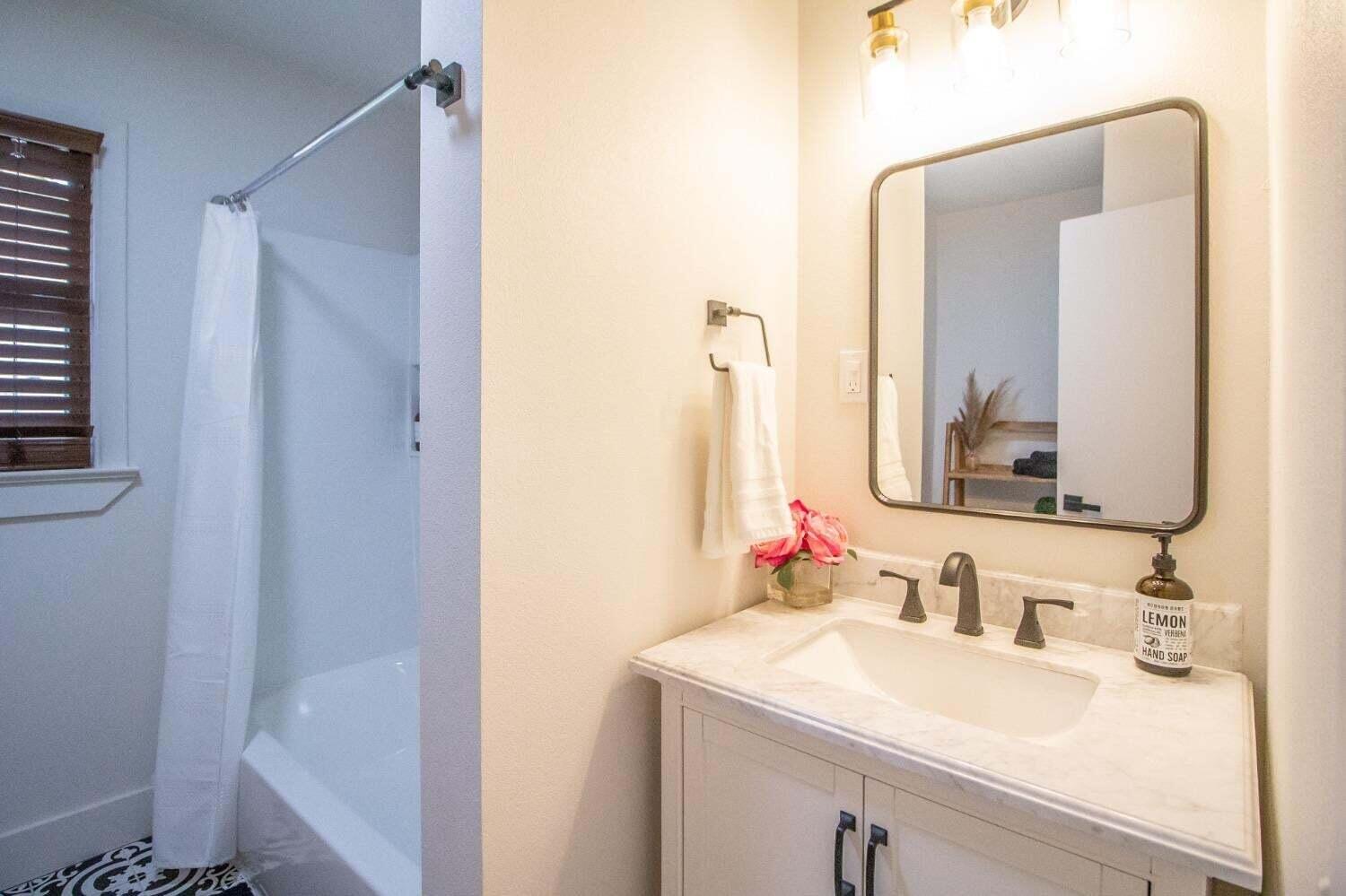 3501 33rd Street Lubbock, TX 79410 - Photo 22 of 34 a bathroom with a sink and a mirror