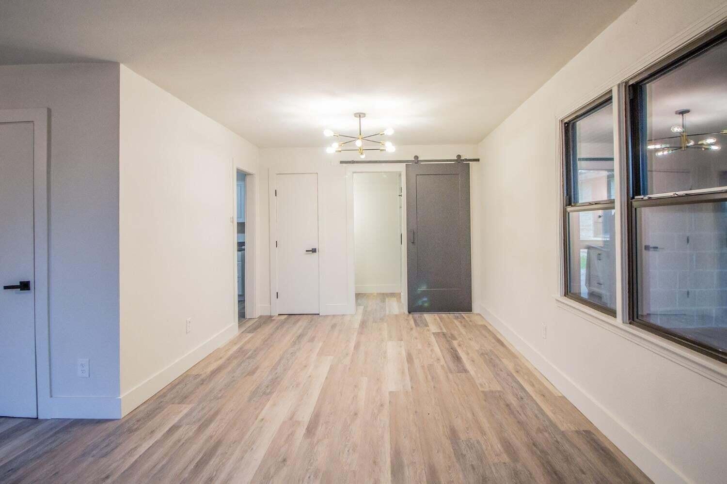 3501 33rd Street Lubbock, TX 79410 - Photo 29 of 34 a view of a room with wooden floor chandelier and closet