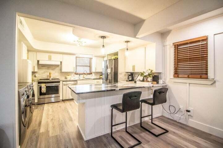 3501 33rd Street Lubbock, TX 79410 - Photo 8 of 34 a kitchen with a sink a counter top space appliances and a window