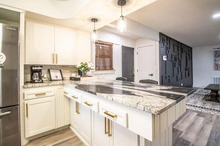 3501 33rd Street Lubbock, TX 79410 - Photo 10 of 34 a kitchen with granite countertop a sink stove and refrigerator