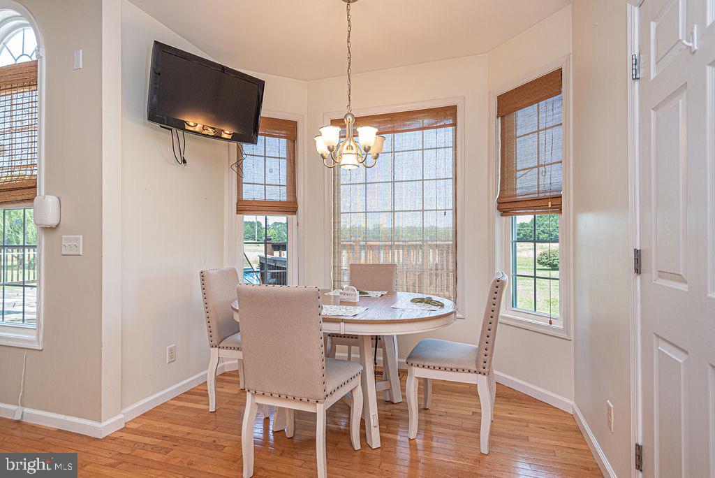 10671 Cathell Road Berlin, MD 21811 - Photo 15 of 63 a view of a dining room with furniture window and wooden floor