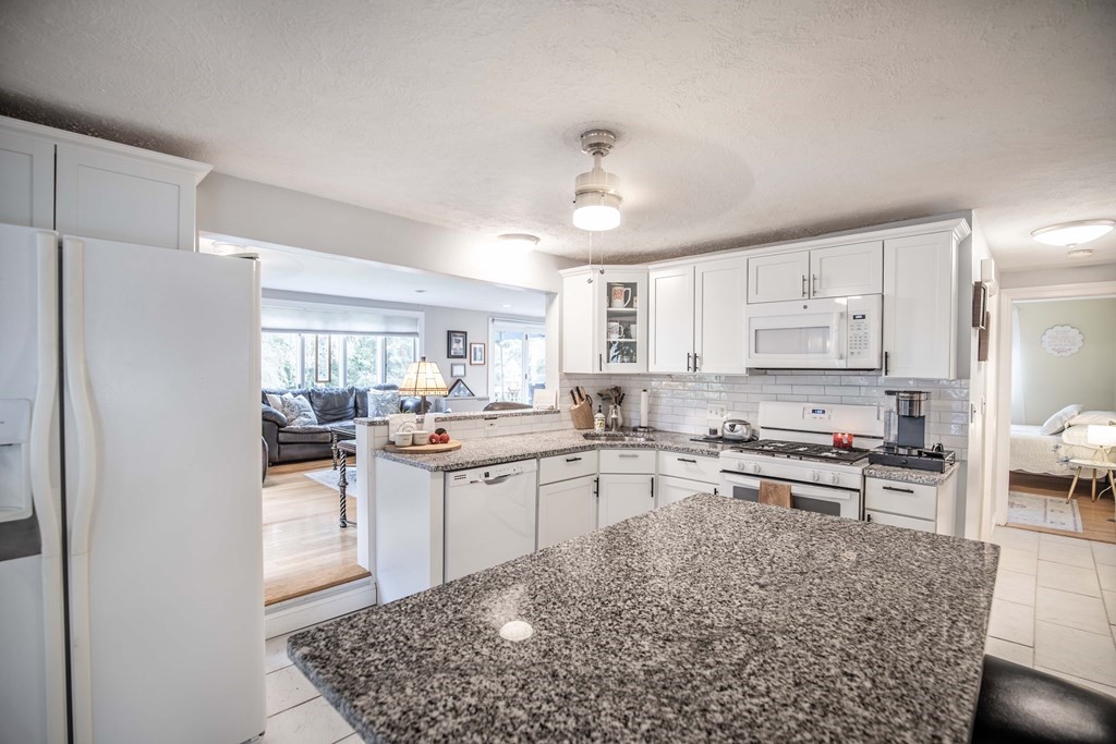 96 Wyman Road Billerica, MA 01821 - Photo 13 of 35 a kitchen with stainless steel appliances granite countertop a sink stove and refrigerator