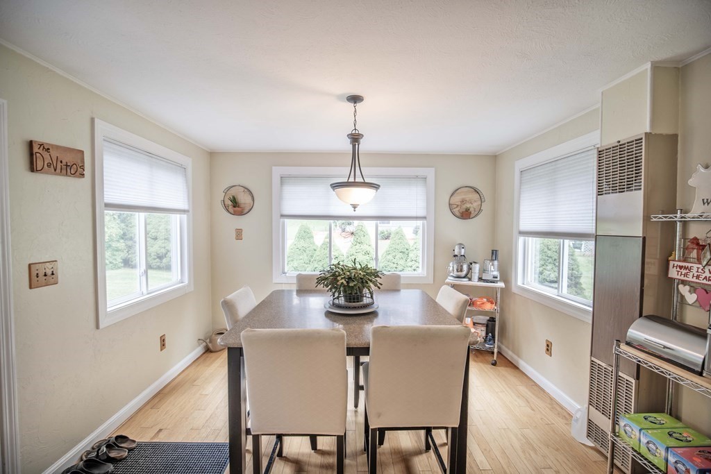 96 Wyman Road Billerica, MA 01821 - Photo 17 of 35 a dining room with furniture a chandelier and wooden floor