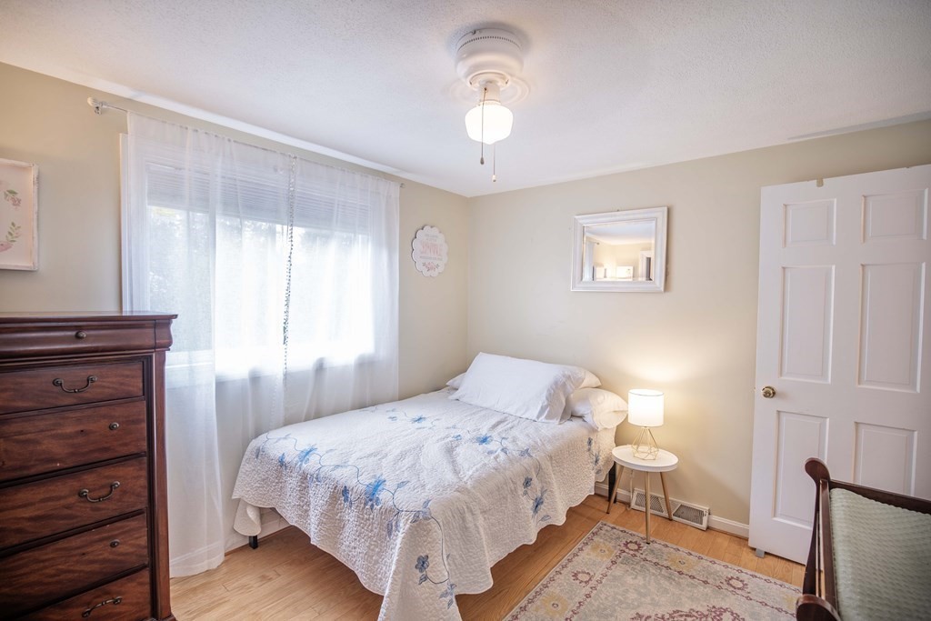 96 Wyman Road Billerica, MA 01821 - Photo 23 of 35 a bedroom with a bed and a window