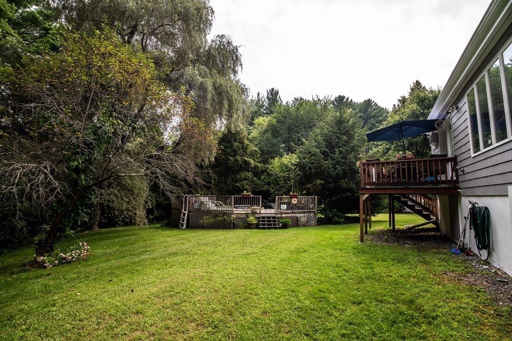 96 Wyman Road Billerica, MA 01821 - Photo 34 of 35 a view of a swimming pool with a bench and trees