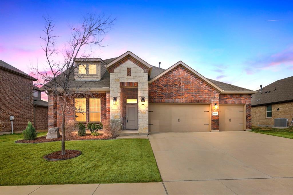 2909 Faro Road Aubrey, TX 76227 - Photo 1 of 32 a front view of a house with a yard and garage
