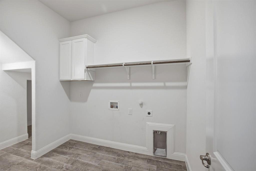 2909 Faro Road Aubrey, TX 76227 - Photo 12 of 32 a view of storage and utility room with empty racks