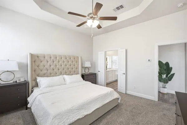 a bedroom with a bed and a chandelier