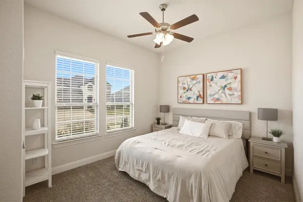 a bedroom with a large bed and a window