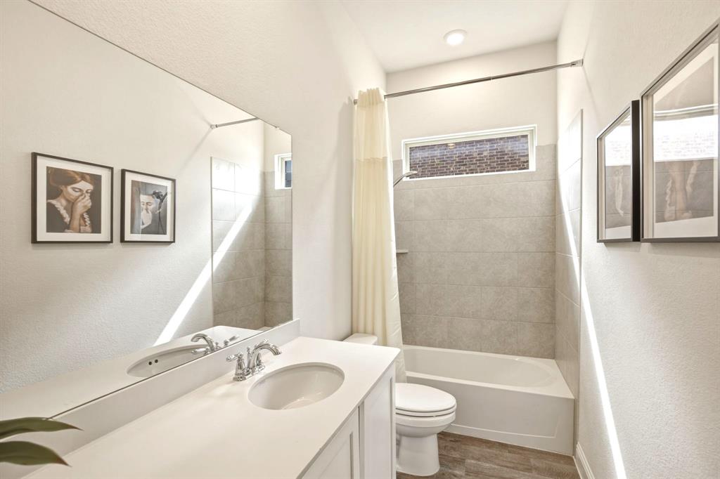 2909 Faro Road Aubrey, TX 76227 - Photo 17 of 32 a bathroom with a sink and a mirror