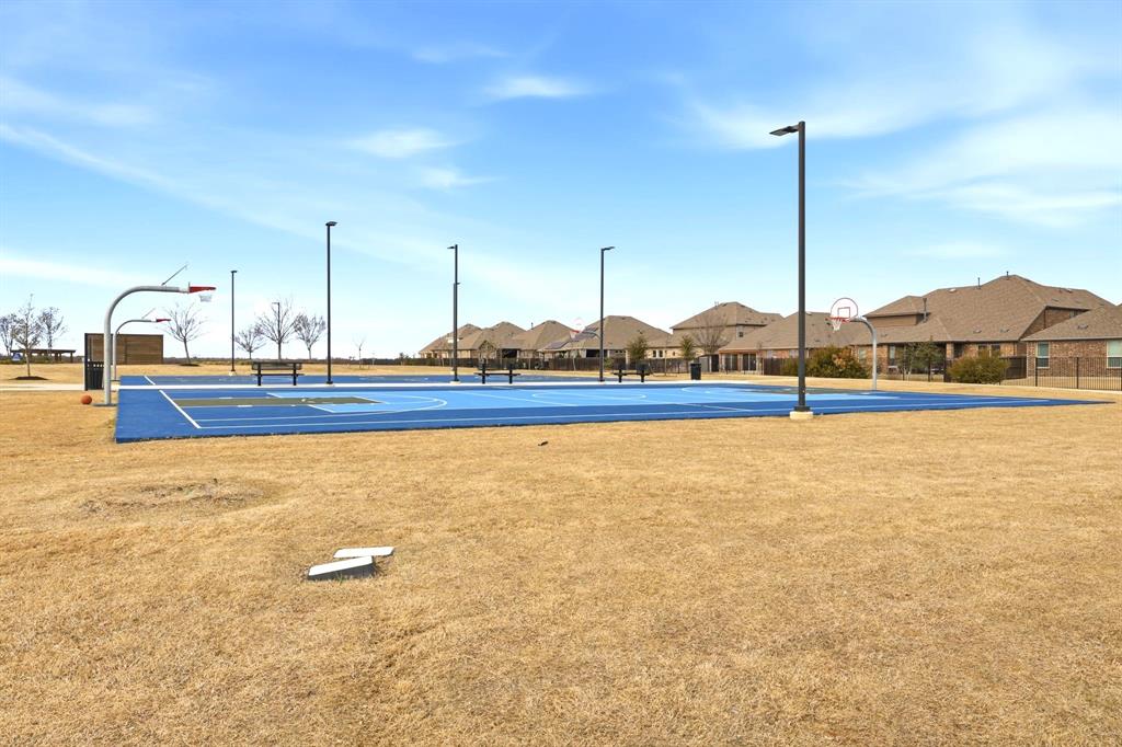 2909 Faro Road Aubrey, TX 76227 - Photo 29 of 32 a view of a swimming pool with a lawn chairs