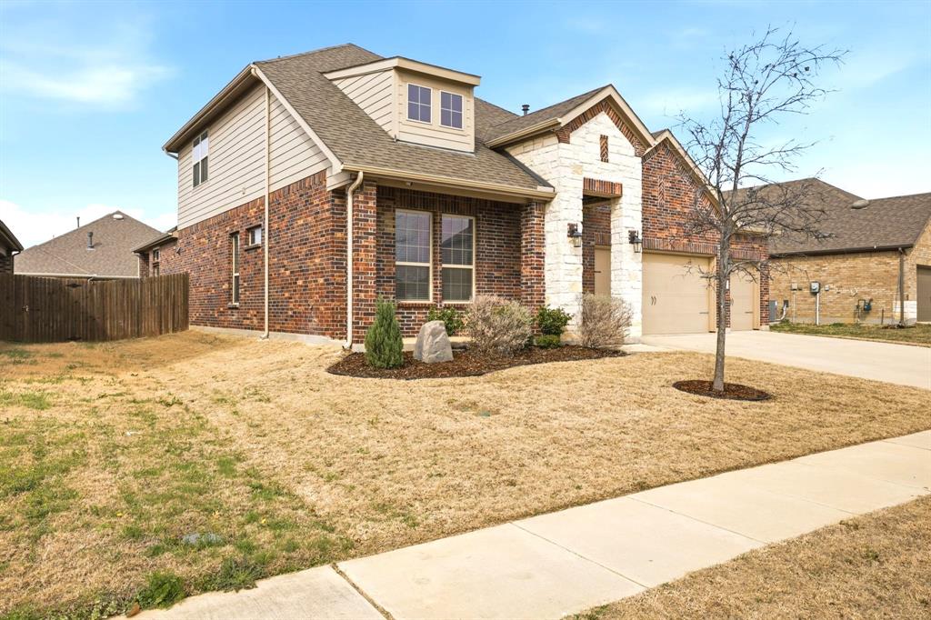 2909 Faro Road Aubrey, TX 76227 - Photo 3 of 32 a front view of a house with a yard and garage