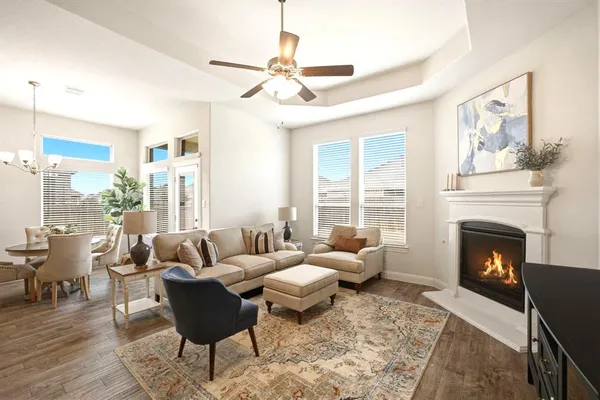 a living room with furniture fireplace and a large window