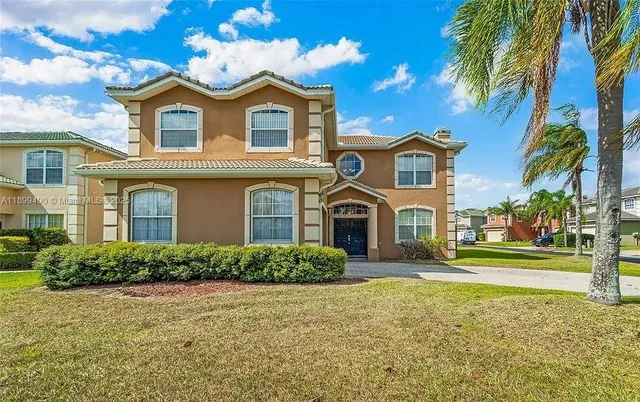 a front view of a house with a garden