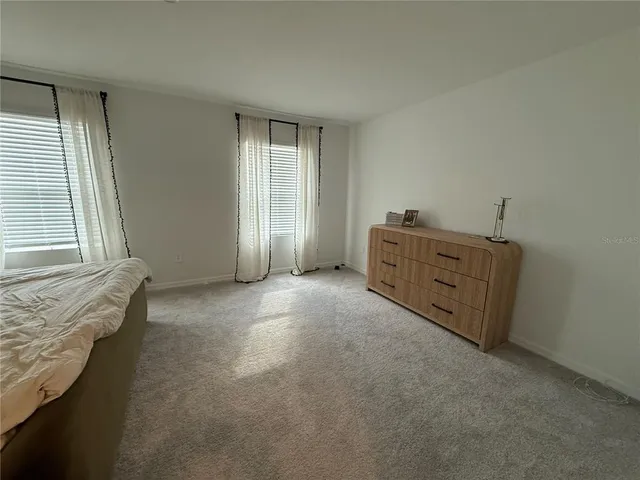 a bedroom with a bed and a rug