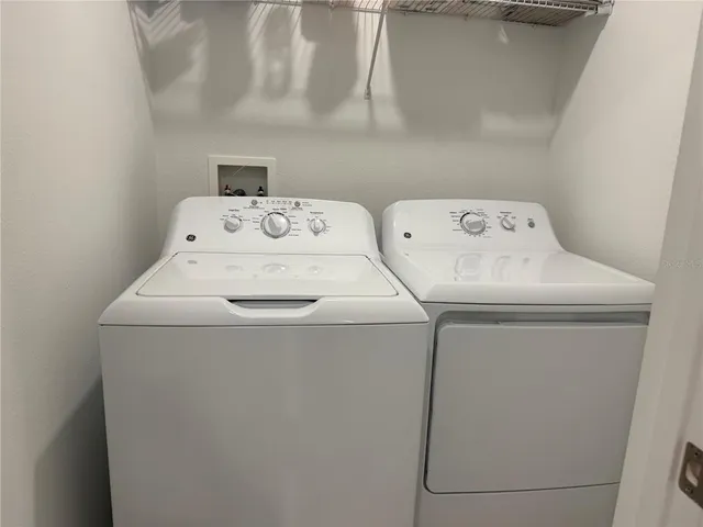 a white toilet sitting next to a white sink