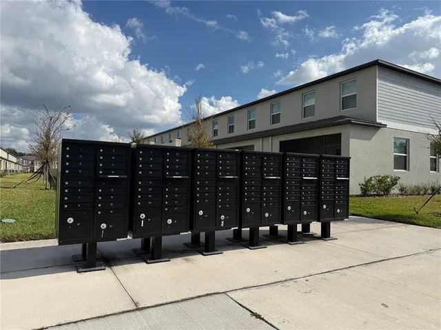 a building outdoor space with patio furniture and potted plants