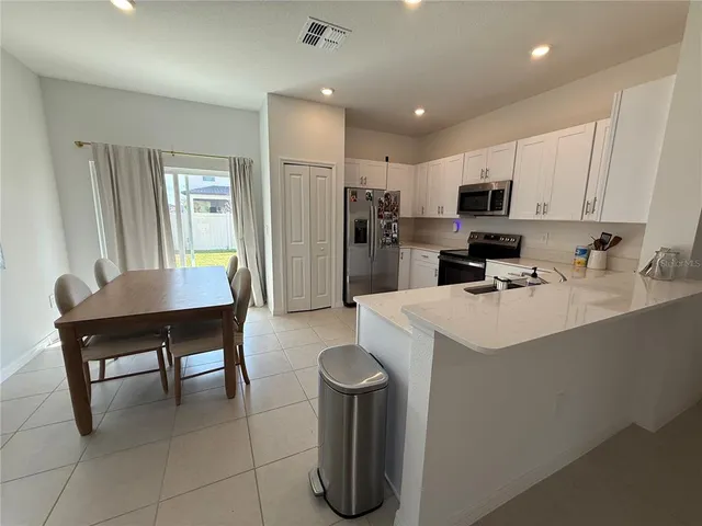 a kitchen with furniture a sink and a refrigerator