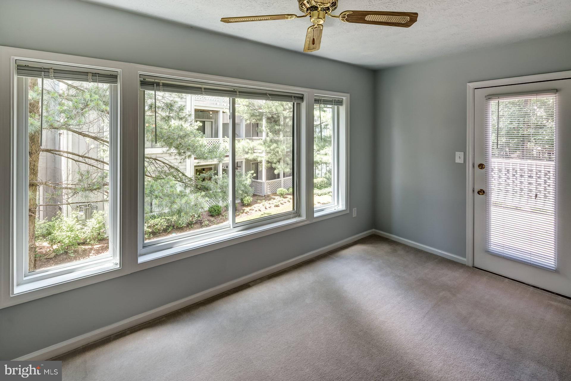 2283 Hunter's Run Drive, Unit 2283 Reston, VA 20191 - Photo 7 of 23 Sunroom open to south-facing Deck