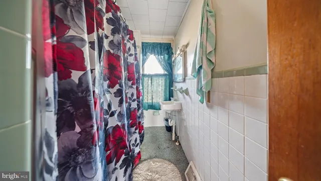 a bed room with a bed and a ceiling fan