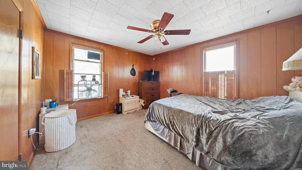 a bedroom with a bed and flat screen tv
