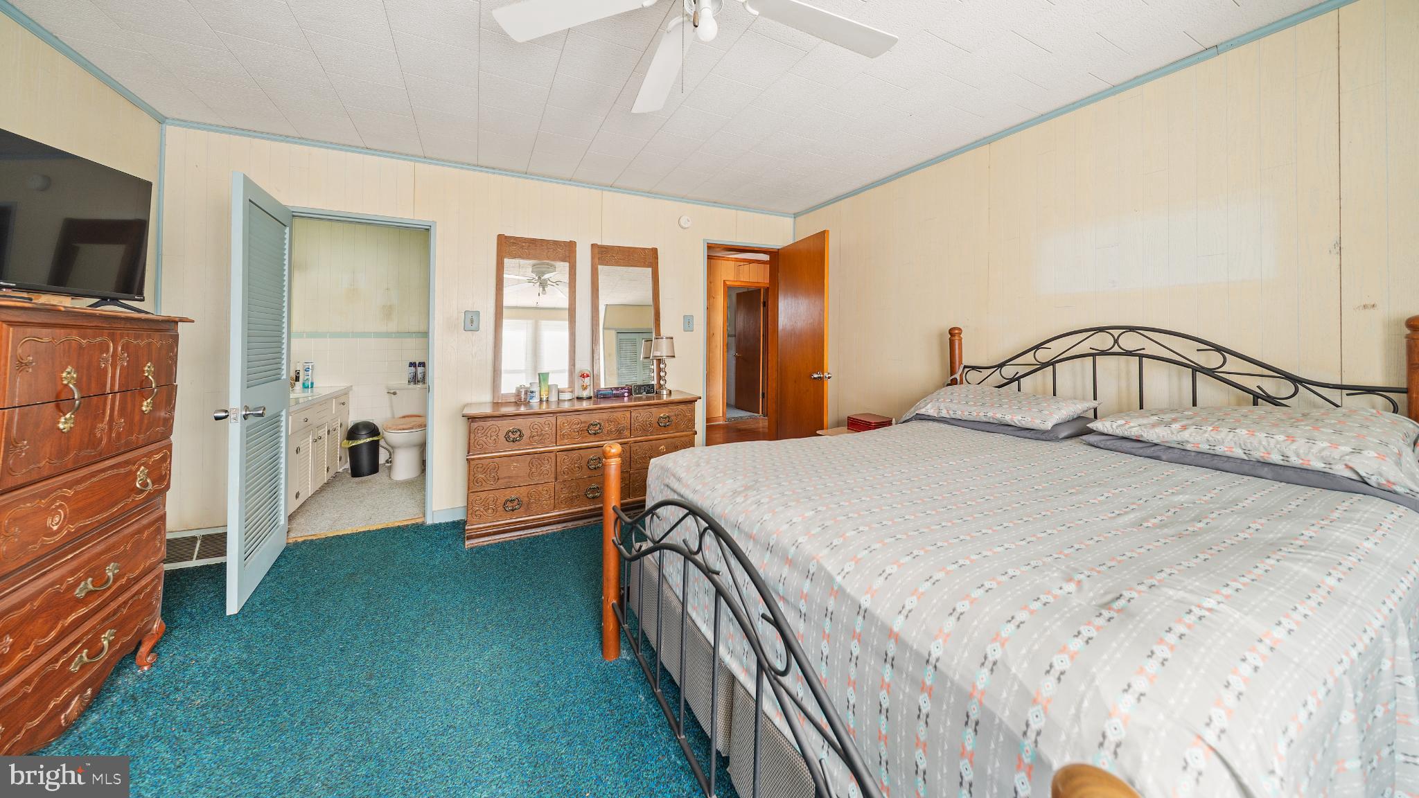 701 East State Street Delmar, DE 19940 - Photo 15 of 23 a bedroom with a bed and a flat tv screen on dresser
