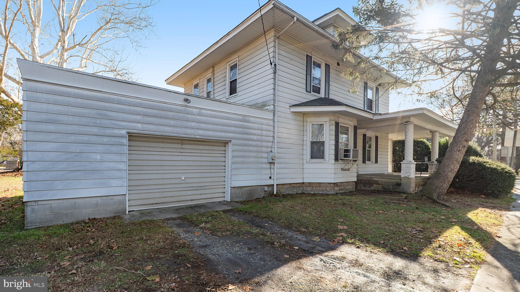 701 East State Street Delmar, DE 19940 - Photo 19 of 23 a view of a white house next to a yard with wooden fence