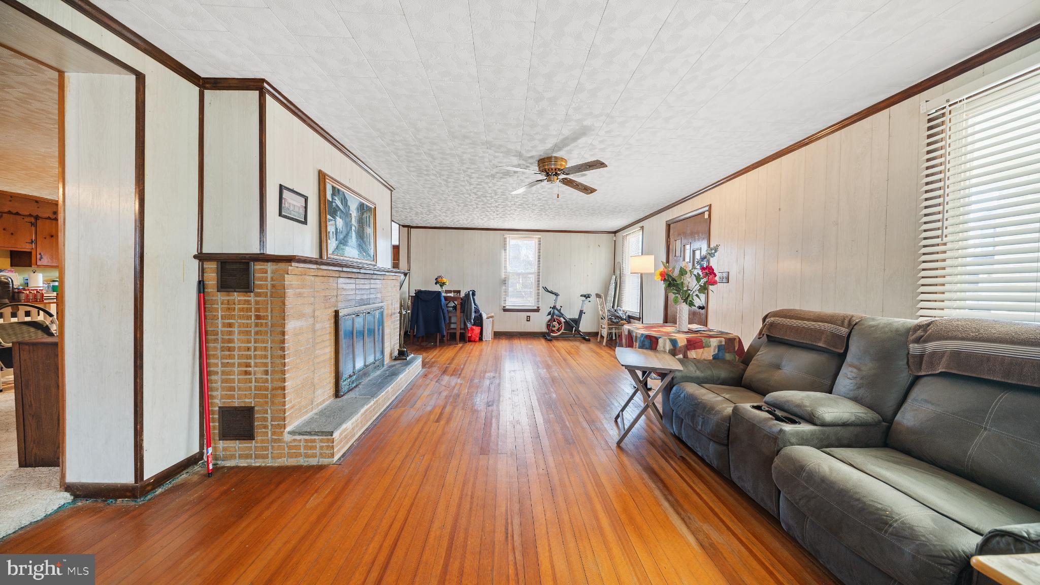 701 East State Street Delmar, DE 19940 - Photo 5 of 23 a living room with fireplace furniture and a wooden floor