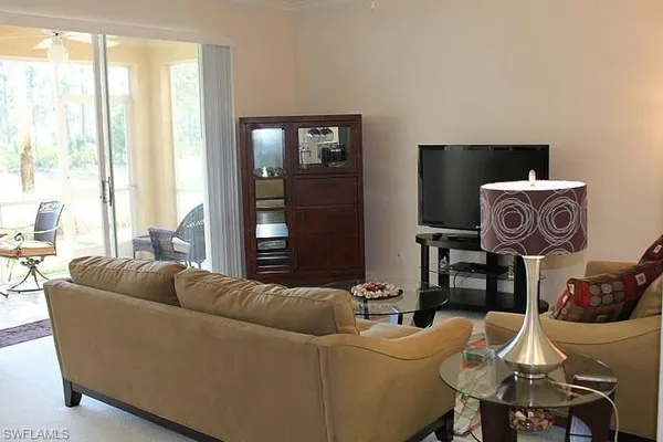 a view of living room with furniture and lamp