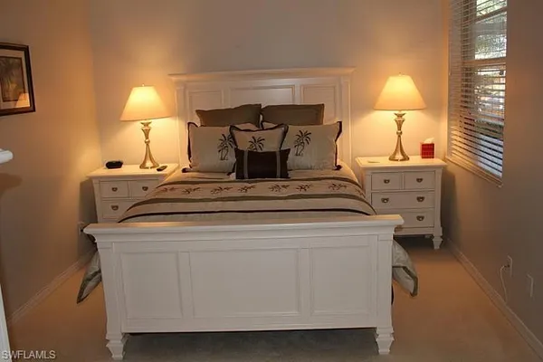 a bed room with a bed and a night stand