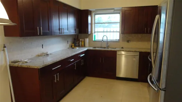 a kitchen with a sink a stove and refrigerator