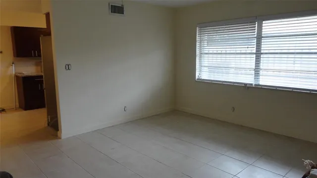 a view of an empty room with a window