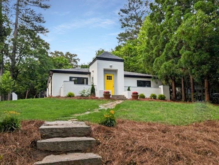460 Wimbledon Road Northeast Atlanta, GA 30324 - Photo 1 of 1 a front view of a house with a yard and trees