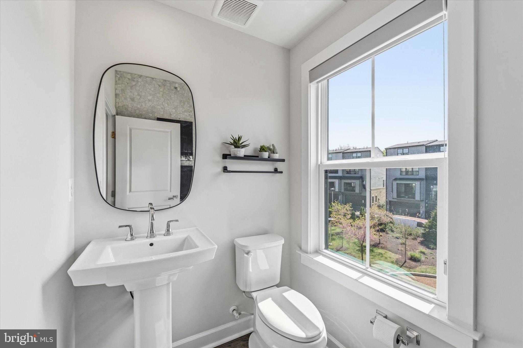 12915 Sunrise Ridge Alley, Unit 74 Herndon, VA 20171 - Photo 16 of 48 a bathroom with a toilet sink and mirror