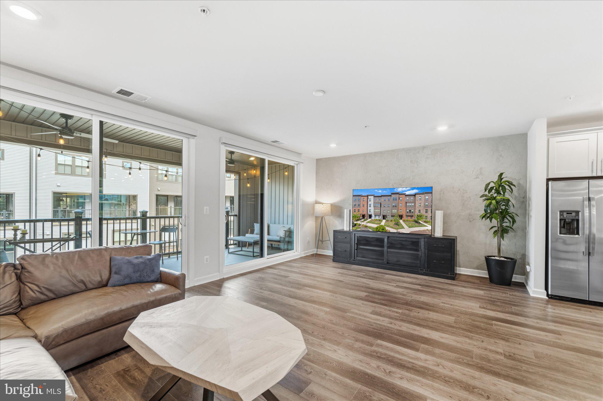 12915 Sunrise Ridge Alley, Unit 74 Herndon, VA 20171 - Photo 18 of 48 a living room with furniture and a large window