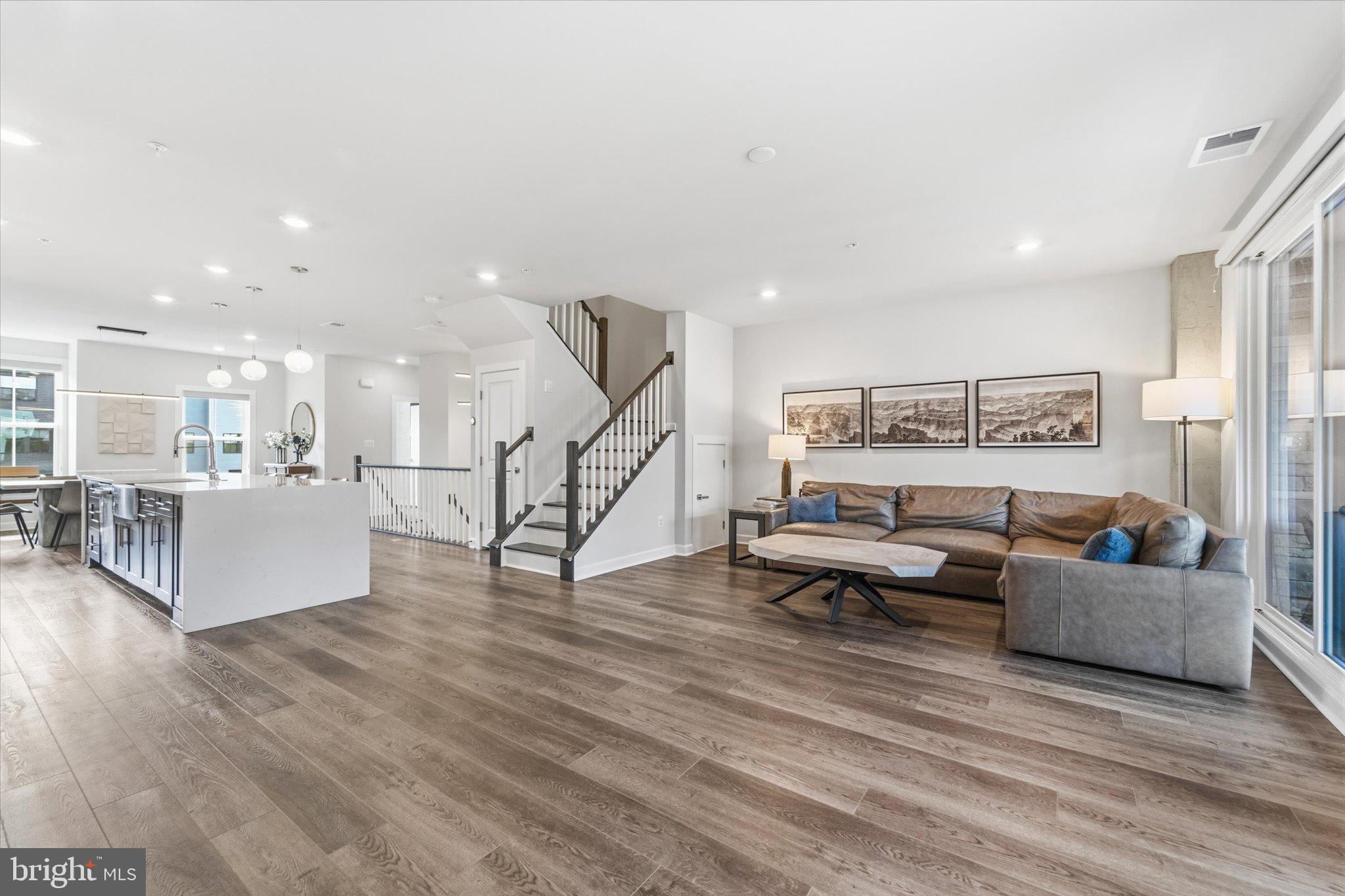 12915 Sunrise Ridge Alley, Unit 74 Herndon, VA 20171 - Photo 48 of 48 a living room with furniture and a wooden floor