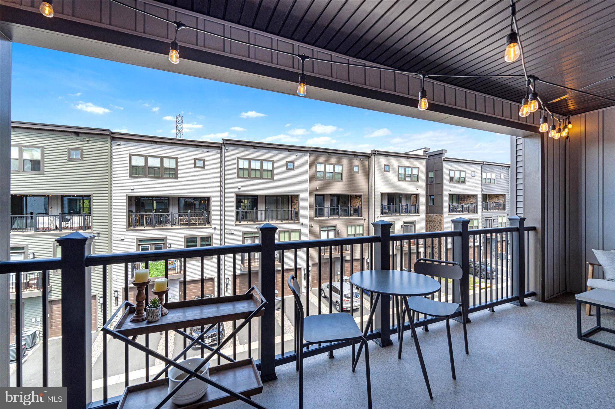 12915 Sunrise Ridge Alley, Unit 74 Herndon, VA 20171 - Photo 20 of 48 a view of a patio with a table and chairs