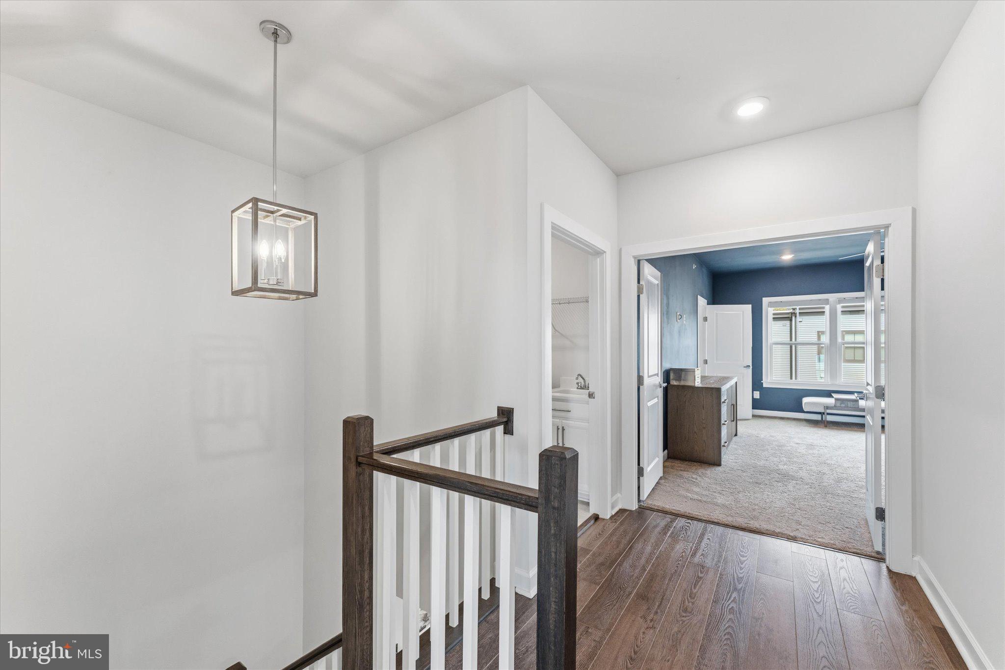 12915 Sunrise Ridge Alley, Unit 74 Herndon, VA 20171 - Photo 21 of 48 a view of a hallway with wooden floor and windows