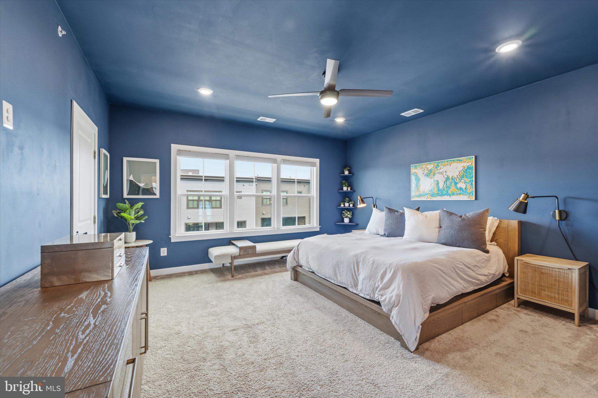12915 Sunrise Ridge Alley, Unit 74 Herndon, VA 20171 - Photo 23 of 48 a spacious bedroom with a large bed and a couch