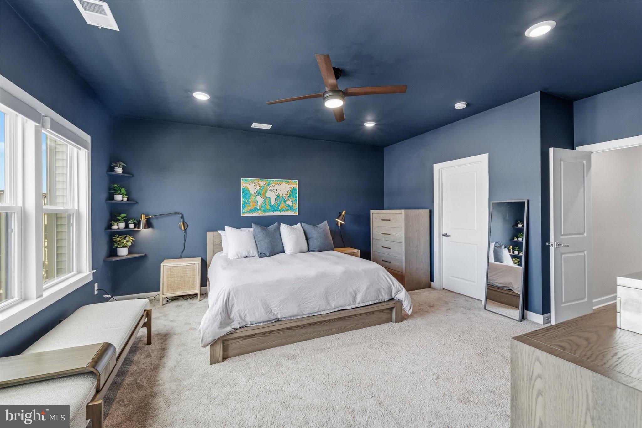 12915 Sunrise Ridge Alley, Unit 74 Herndon, VA 20171 - Photo 24 of 48 a spacious bedroom with a large bed and a chandelier