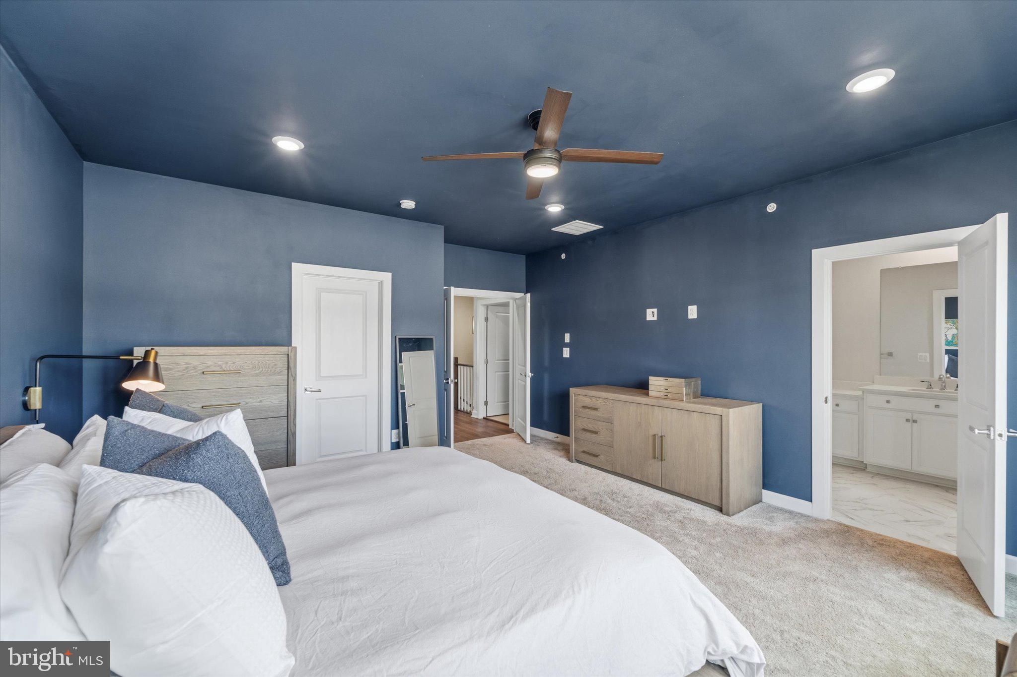 12915 Sunrise Ridge Alley, Unit 74 Herndon, VA 20171 - Photo 25 of 48 a bed room with a bed and a large mirror