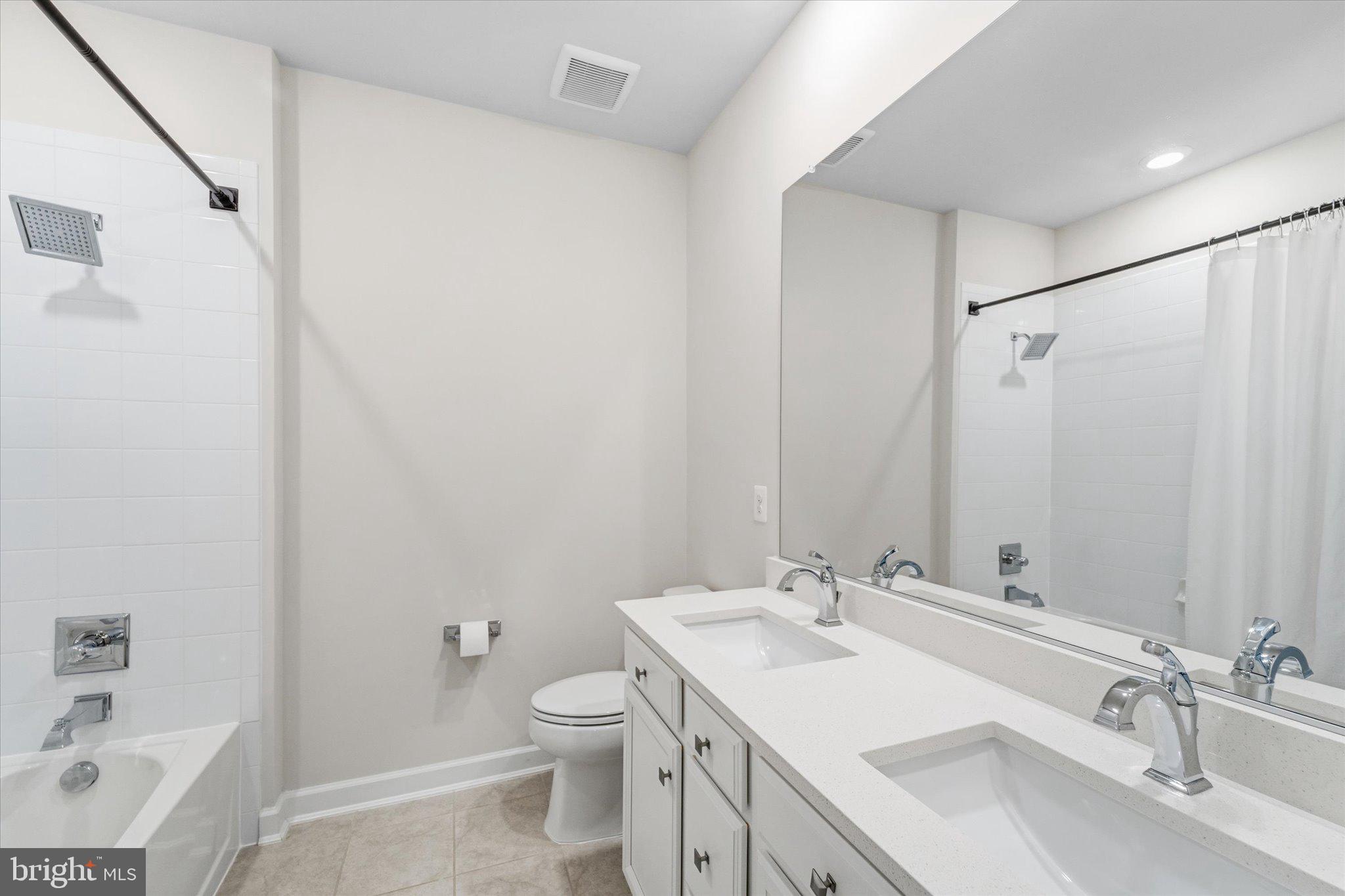 12915 Sunrise Ridge Alley, Unit 74 Herndon, VA 20171 - Photo 28 of 48 a bathroom with a sink toilet and shower