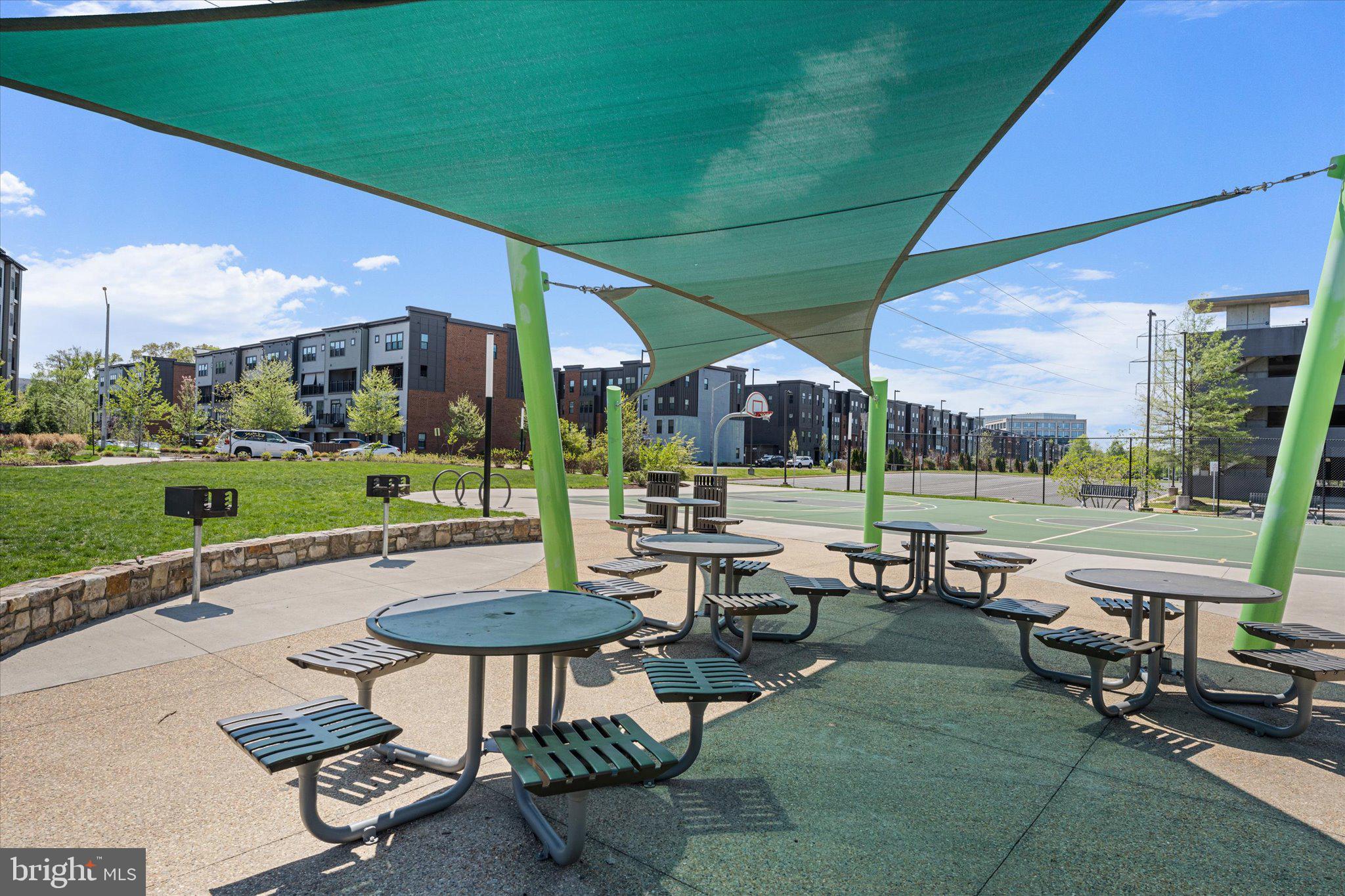 12915 Sunrise Ridge Alley, Unit 74 Herndon, VA 20171 - Photo 37 of 48 a view of a patio with a table chairs and a backyard