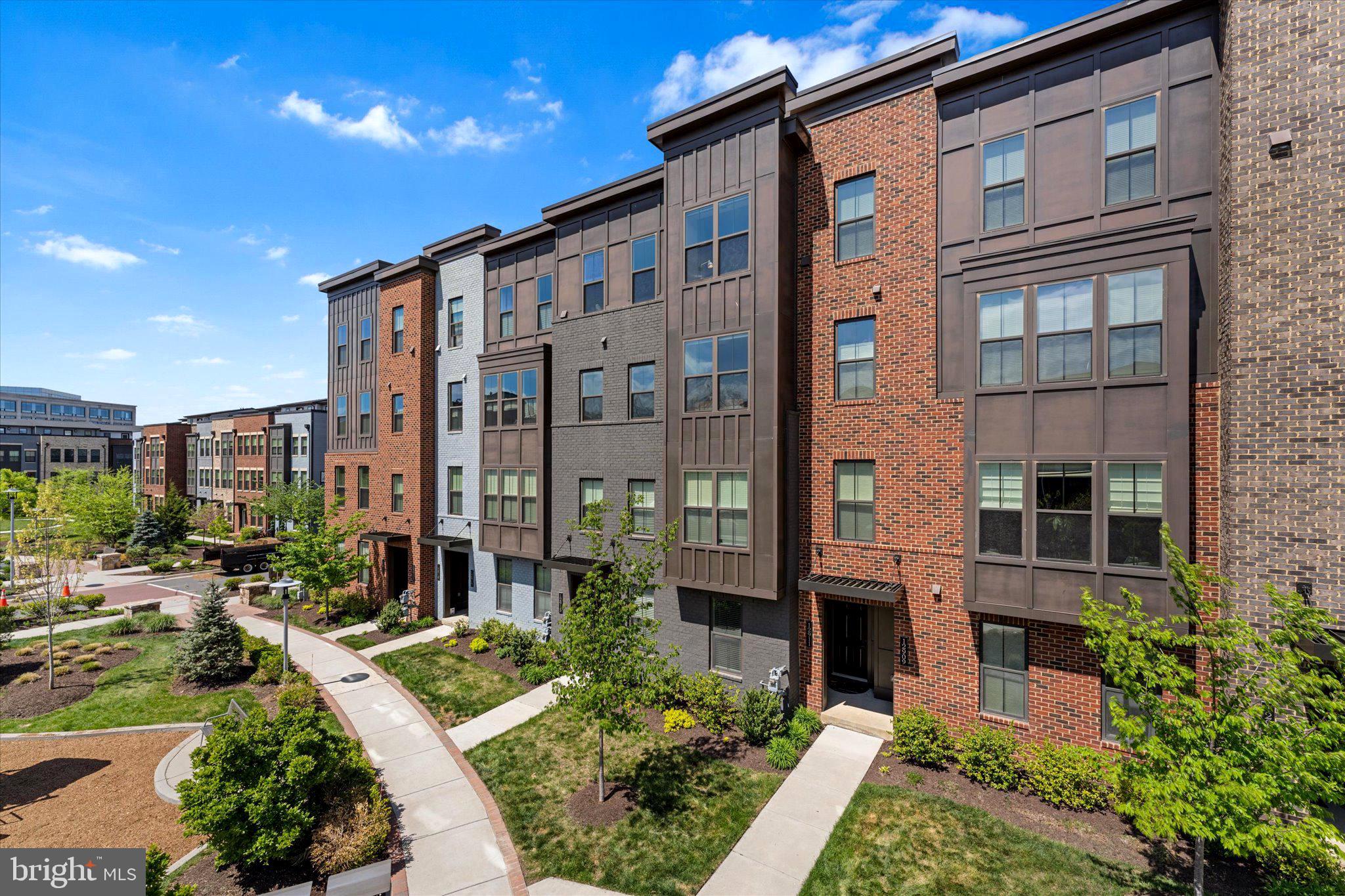 12915 Sunrise Ridge Alley, Unit 74 Herndon, VA 20171 - Photo 8 of 48 a front view of a building with a garden