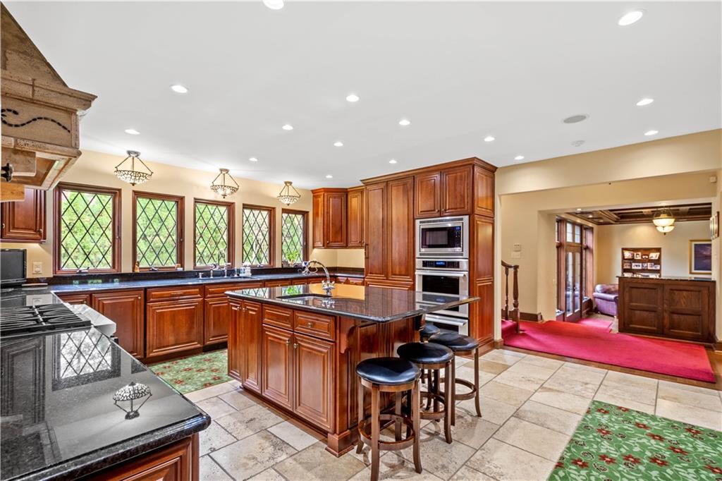 776 Valleyview Road Pittsburgh, PA 15243 - Photo 8 of 25 a kitchen with stainless steel appliances granite countertop a stove and a dining table chair