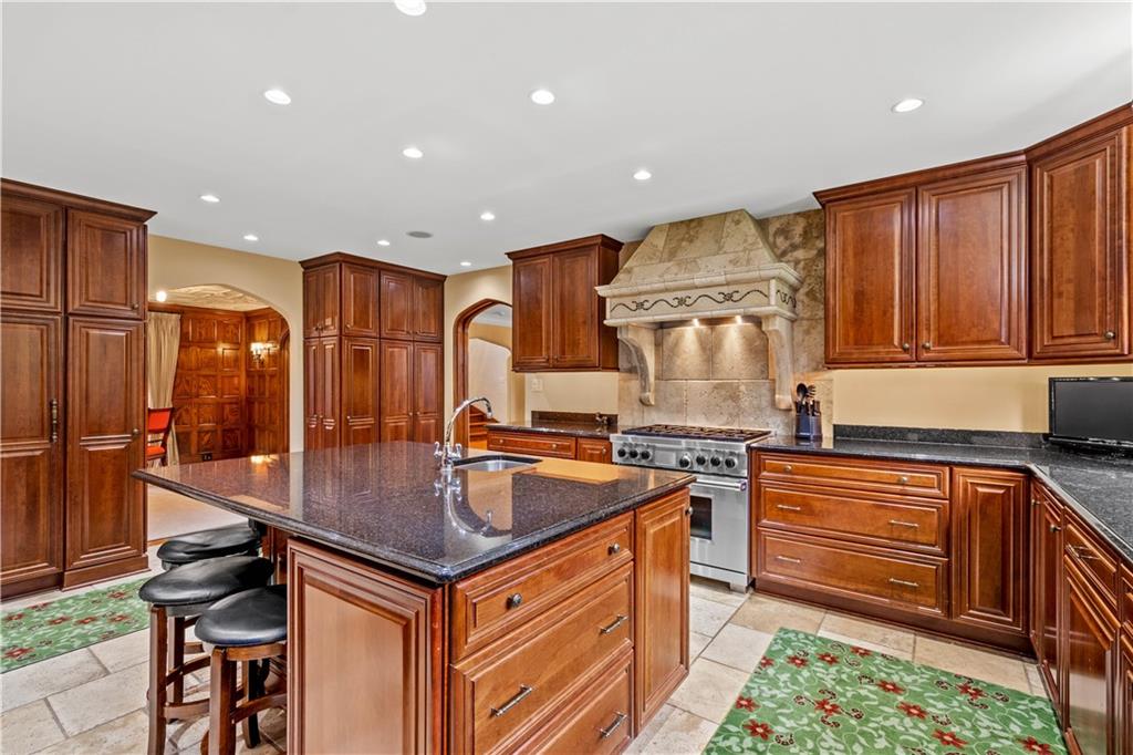 776 Valleyview Road Pittsburgh, PA 15243 - Photo 9 of 25 a kitchen with stainless steel appliances granite countertop a sink stove and refrigerator