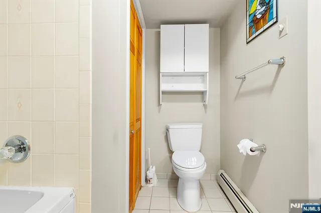 a white toilet sitting next to a bathroom sink