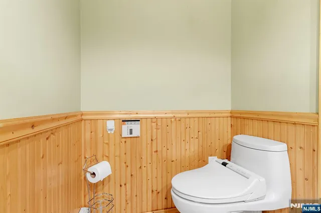 a white toilet sitting next to a shower curtain
