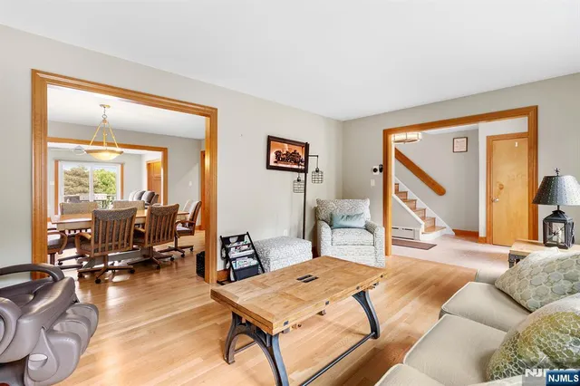 a living room with furniture a flat screen tv and a large window