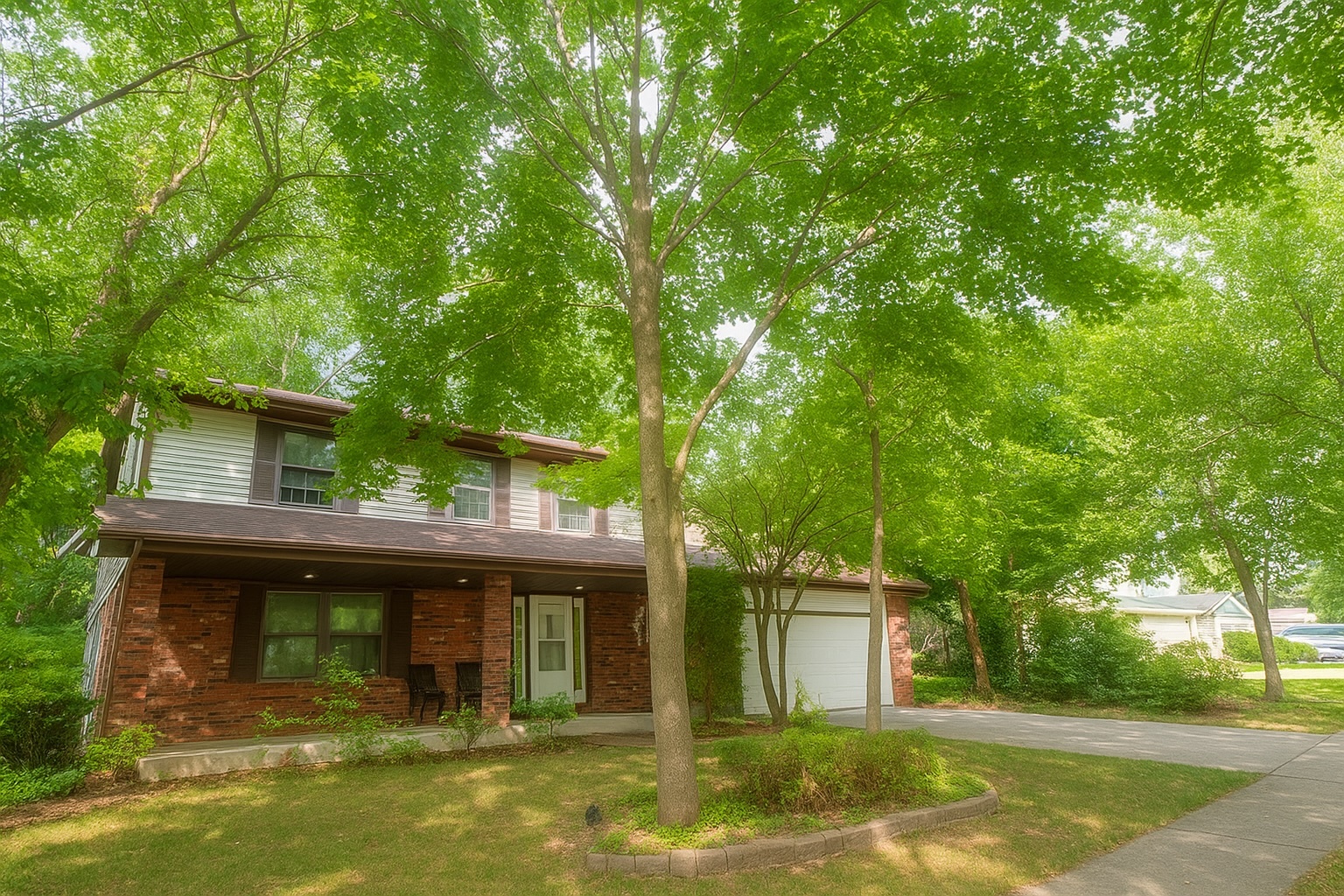 a front view of a house with a tree
